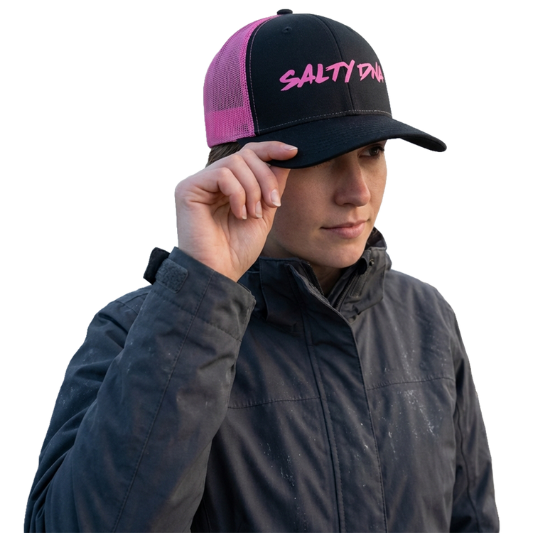 Woman wearing a black and hot pink Salty DNA mesh snapback
