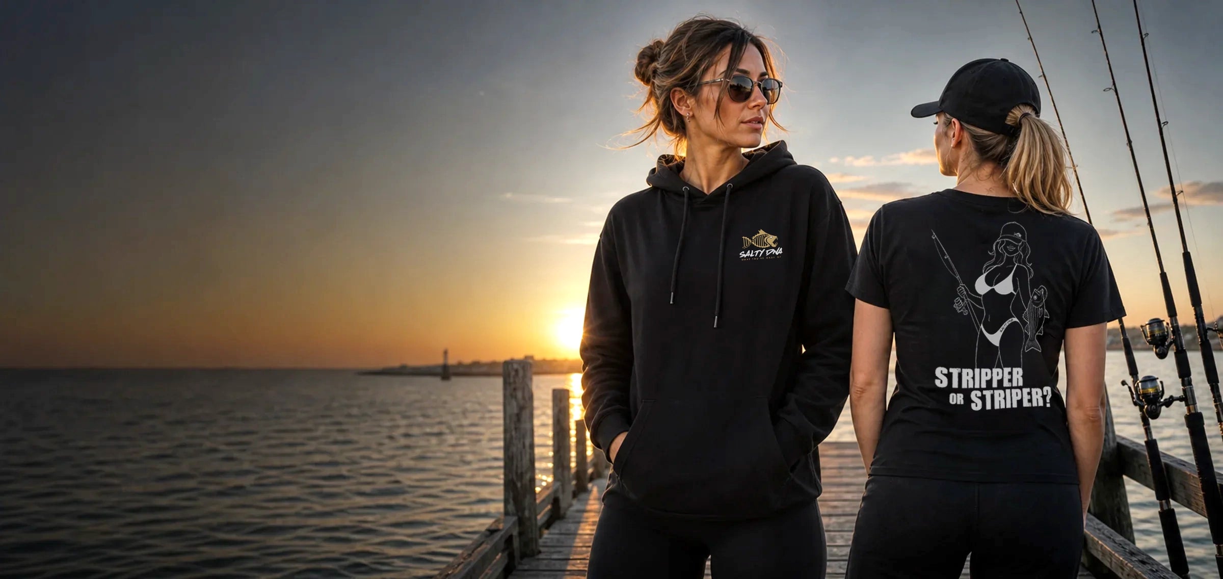 Two women wearing black Salty DNA Salty Girls merch on a coastal dock